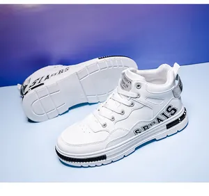 Detail view of white mid-top synthetic leather skate shoes with side logo design.