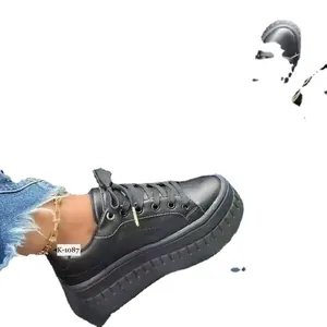 Women's black platform sneakers with round toe and thick ridged sole for casual wear.