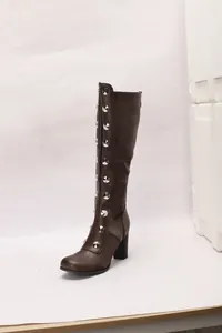 Side view of brown knee-high boots with silver stud rivets and chunky heels