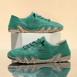 Close-up view of green leather casual shoes with unique octopus style soles and white stitching