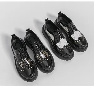 Artistic black patent leather shoes with rivets and intricate branch patterns