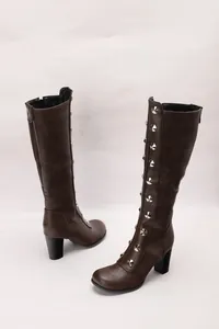 Detailed view of brown chunky heel knee-high boots with silver stud decorations