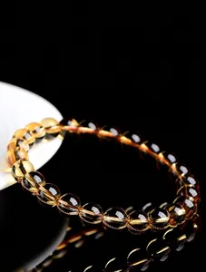 High-quality natural citrine bracelet featuring clear round beads with vibrant golden color.