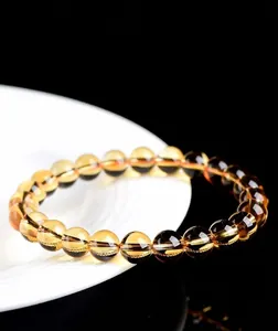 Close-up of 7A grade natural citrine beaded bracelet on white plate