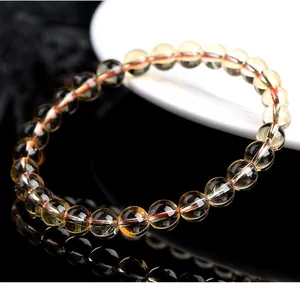 Close-up detail of natural yellow citrine bracelet featuring translucent round beads.