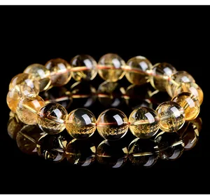 Close-up of a natural citrine bead bracelet with clear golden texture and reflection