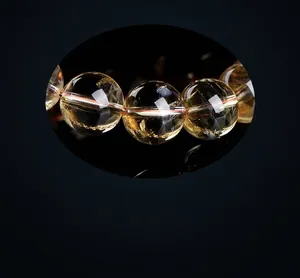 Macro detail of natural yellow citrine beads showing clear texture and ice cracks