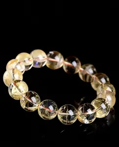 Macro view of high-grade natural yellow citrine round bead bracelet with clear texture