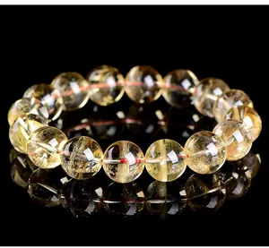 Close-up detail of natural yellow citrine crystal beads on elegant black background