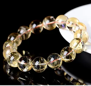 Macro view of natural citrine gemstone bead bracelet showing clear yellow crystal textures.
