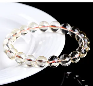 Close-up of a natural citrine bead bracelet with high transparency on a white plate
