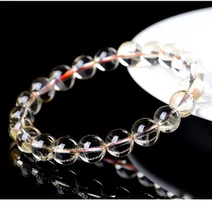 Close-up macro view showing texture of natural yellow citrine crystal beads on a bracelet