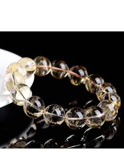 Macro view of a natural citrine bead bracelet showing clear yellow crystal textures
