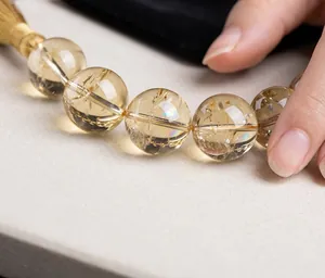 Detailed macro view of transparent natural yellow citrine beads with internal ice cracks