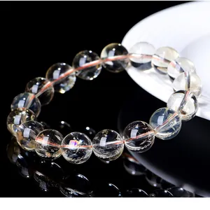 Close-up of high-quality natural citrine crystal beaded bracelet on reflective surface.