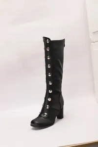 Detailed view of black knee-high knight boots featuring silver rivets and chunky heels