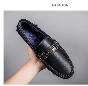 Close-up of black men's loafers with warm blue plush lining and gold buckle detail.