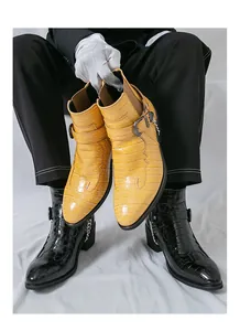 Close-up of men's crocodile pattern Chelsea boots shown in black and yellow colors.