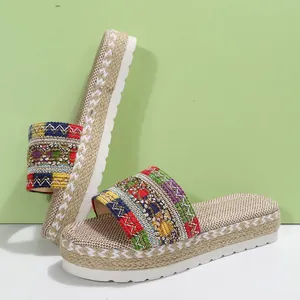 Detailed view of colorful bohemian woven straps and jute-wrapped platform soles.