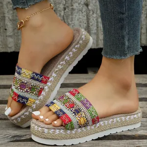 Detailed macro view of ethnic style platform slides with colorful candy-colored woven straps