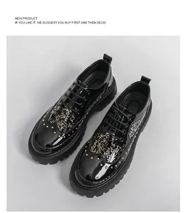 Detail view of black patent leather brogues with rivets and branch pattern.
