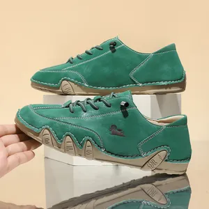 Detailed side view of green wide-toe leather casual shoes with a unique octopus-style sole design.