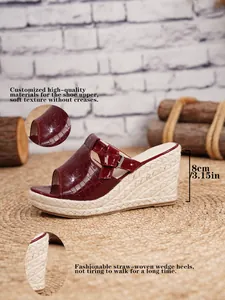 Detailed view of burgundy patent leather wedge sandal with 8cm straw-woven platform.