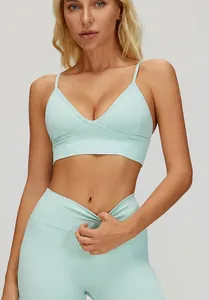 Close-up of mint green V-neck ribbed sports bra with thin adjustable straps for yoga