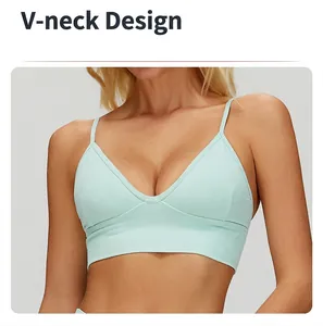 Close-up of a mint green V-neck yoga sports bra with thin straps and ribbed fabric texture.