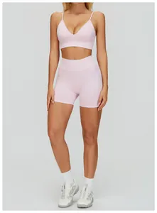 Front view detail of a light pink V-neck sports bra and matching yoga shorts set