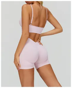 Back view of pink sports bra with thin adjustable straps and ribbed texture shorts