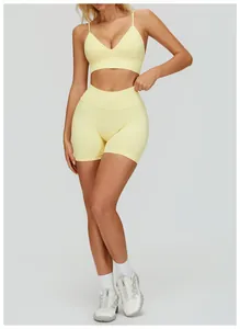 Full view of pale yellow V-neck sports bra and high-waisted fitness shorts set