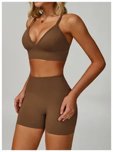 Close-up of a brown V-neck yoga sports bra and matching high-waisted shorts on a model