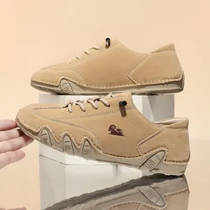 Close-up of tan low-top casual shoes featuring unique octopus-style rubber soles and side logo