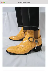 Detail view of men's yellow crocodile pattern Chelsea boots with buckle and chain