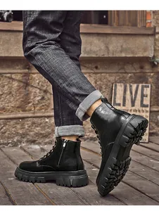 Detailed view of high-quality black leather Martin boots featuring a side zipper design.
