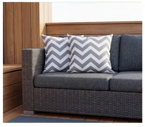 Set of two outdoor waterproof cushion covers with grey chevron pattern on a wicker sofa