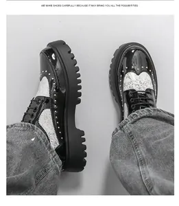 Close-up of black and white platform oxford shoes with metal studs and patterns