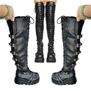 Detailed view of black gothic platform over-the-knee boots with buckles and laces.