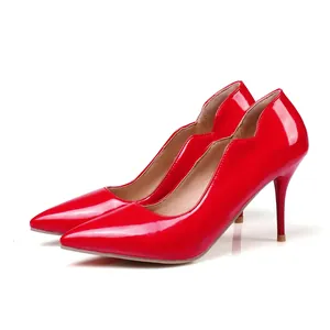 Red patent leather pointed toe stiletto pumps with scalloped edges for elegant office wear