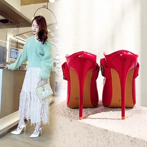 Detail showing the elegant back view of red stiletto heels and model wearing white heels