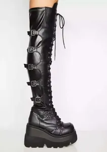 Detailed side view of black over-the-knee platform boots with multiple buckles design