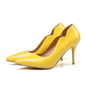 Bright yellow patent leather pointed toe stiletto high heels with wavy edge design