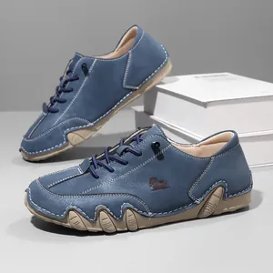 Detailed view of men's blue low-top casual shoes featuring a unique octopus rubber sole