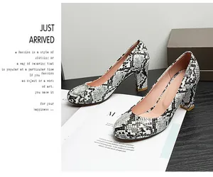 Close-up of stylish snake print round-toe pumps with a stable chunky high heel design