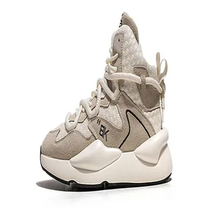 Detailed side view of beige chunky men's sneaker with textured woven fabric