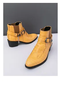 Detailed view of yellow men's Chelsea boots featuring crocodile texture and silver chain