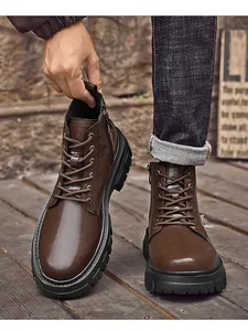 Detailed view of brown leather men's Martin boots with side zipper and rugged rubber sole