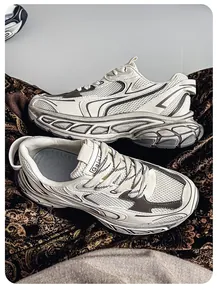 Detailed macro view of men's chunky dad sneakers with mesh upper and thick rubber sole