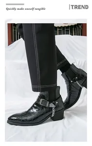 Side view of men's black crocodile texture Chelsea boots with silver chains